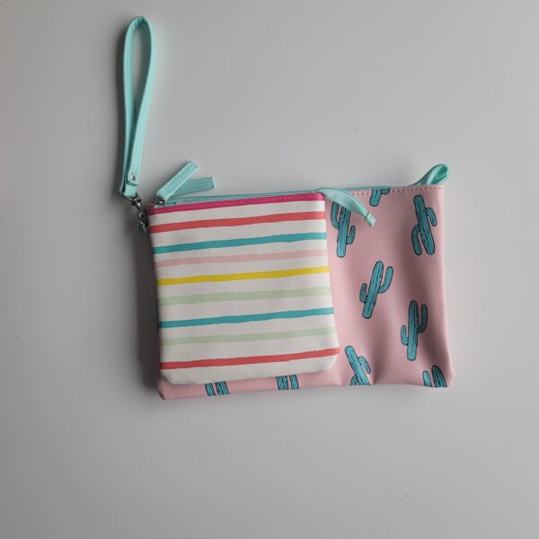 2 Pleather zipped pockets one features colourful stripes, the other features cactus on pink background