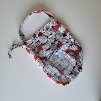 Long red and black crochet project bag with sheep